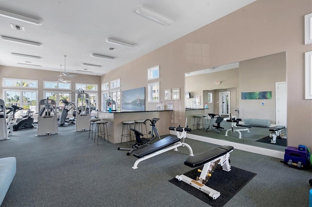 gym with a high ceiling and visible vents