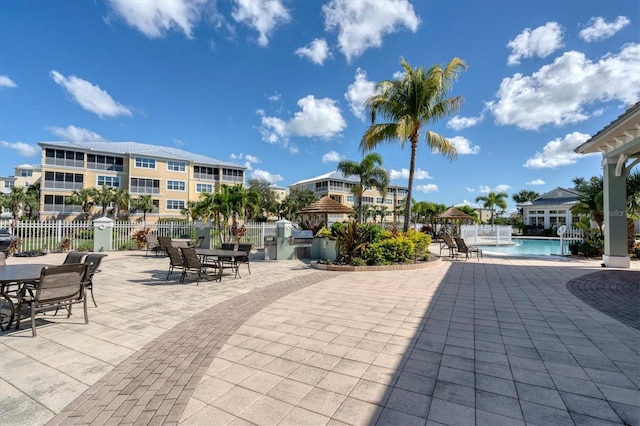 exterior space with a community pool and fence