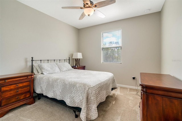 bedroom with baseboards, a ceiling fan, and light colored carpet