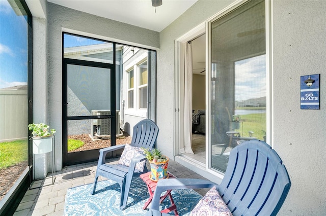 sunroom / solarium featuring ceiling fan