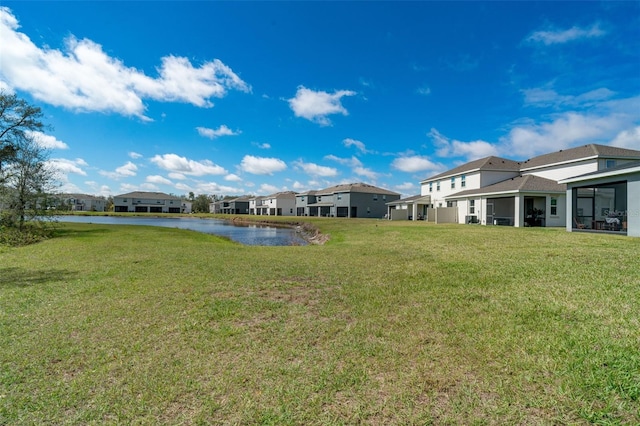 view of yard with a water view and a residential view