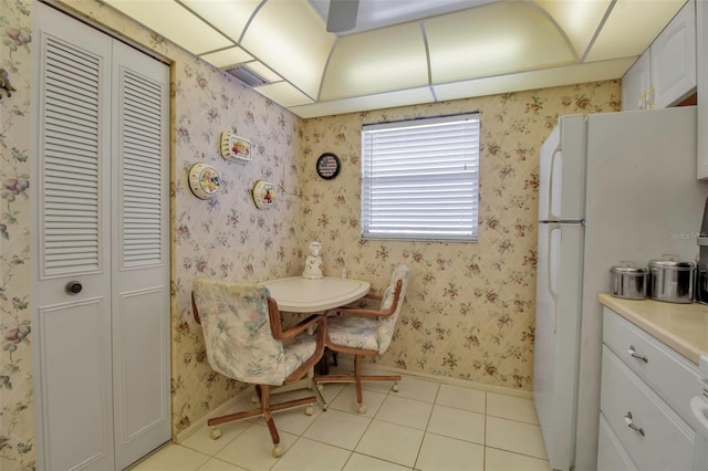 dining space with wallpapered walls, visible vents, light tile patterned floors, and baseboards