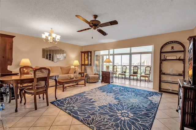 living room featuring a textured ceiling, ceiling fan with notable chandelier, and light tile patterned flooring