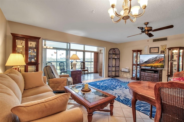 living room featuring ceiling fan with notable chandelier, visible vents, a textured ceiling, and light tile patterned flooring