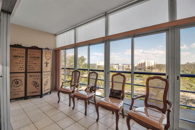 sunroom / solarium with a healthy amount of sunlight and a city view
