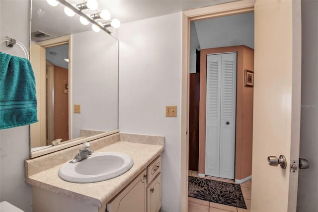 bathroom featuring a closet, visible vents, vanity, and tile patterned floors