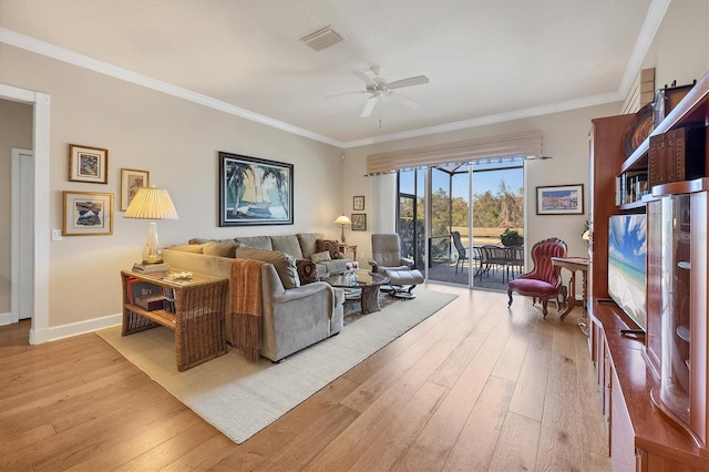 living room featuring ornamental molding, visible vents, and light wood finished floors