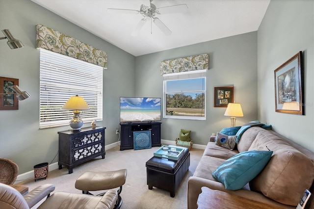 living area featuring ceiling fan, baseboards, and carpet flooring