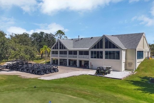 rear view of property with a lawn