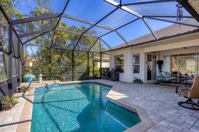 outdoor pool featuring a patio area, a grill, and glass enclosure