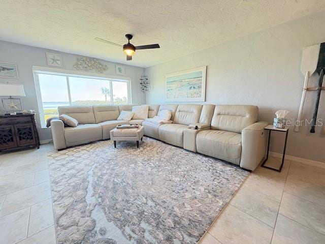 4600 Gulf Of Mexico Dr Unit 202, Longboat Key, FL 34228 - tiled living room featuring a ceiling fan and a textured ceiling
