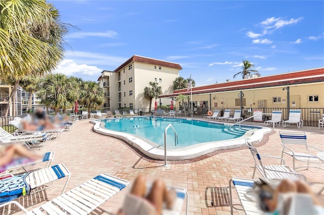 pool with fence and a patio