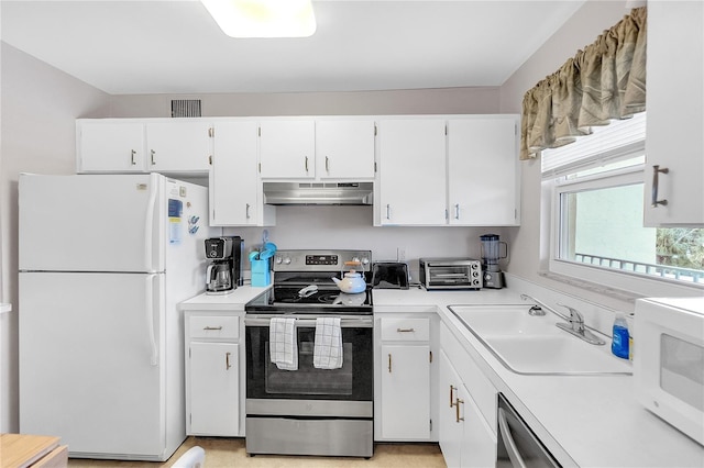 kitchen with stainless steel appliances, light countertops, under cabinet range hood, white cabinetry, and a sink