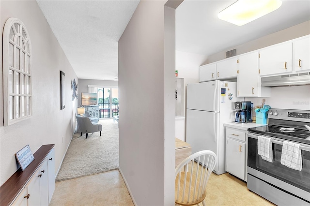 kitchen featuring light colored carpet, under cabinet range hood, white cabinetry, stainless steel electric range, and freestanding refrigerator