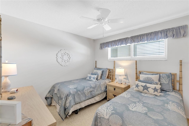 bedroom featuring a ceiling fan and a textured ceiling