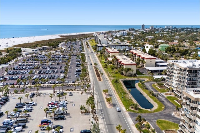 birds eye view of property with a city view, a water view, and a beach view