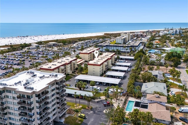 bird's eye view with a water view and a beach view