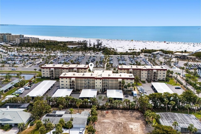 aerial view with a water view and a view of the beach