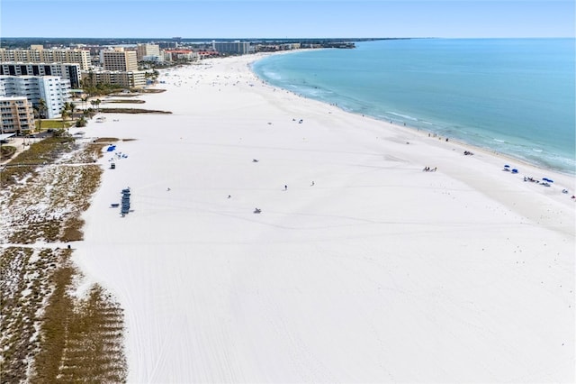 birds eye view of property featuring a water view and a beach view