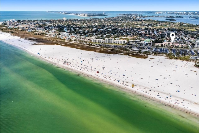 aerial view with a city view, a water view, and a beach view