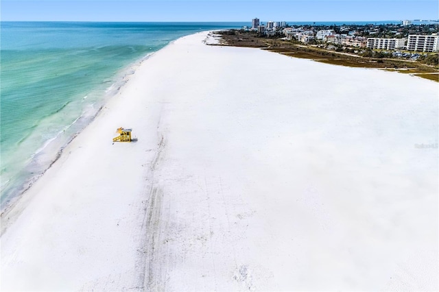 birds eye view of property with a water view and a view of the beach