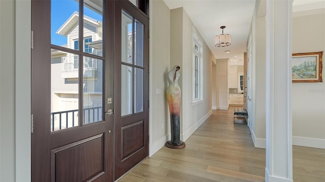 interior space featuring light wood finished floors and baseboards