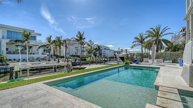 view of swimming pool with a patio area, a residential view, and a fenced in pool