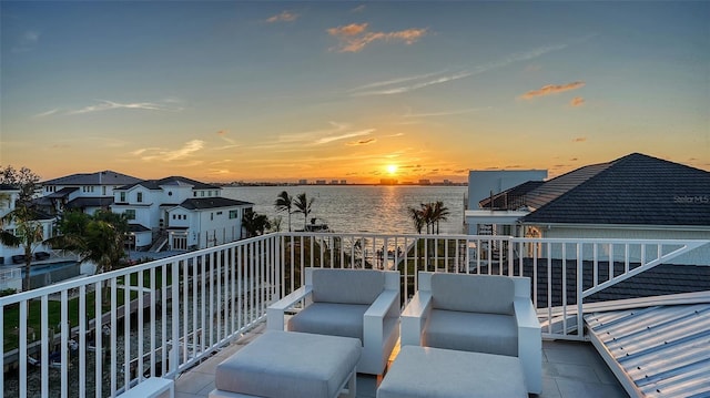 balcony featuring a water view and an outdoor hangout area