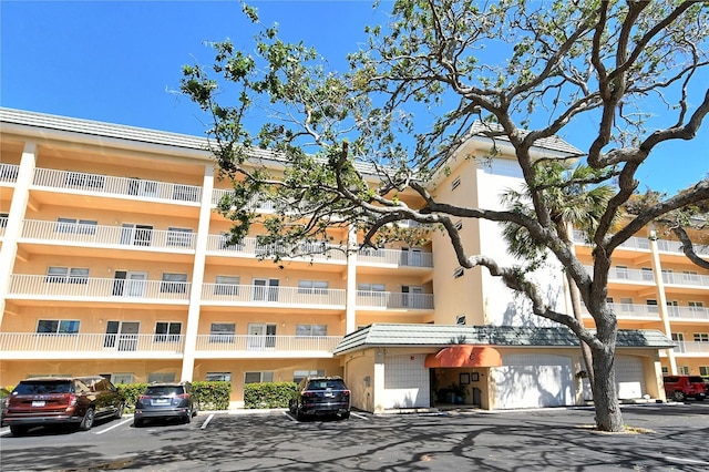 view of building exterior with uncovered parking