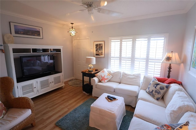 living area with ceiling fan, baseboards, crown molding, and wood finished floors