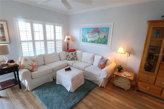 living area featuring light wood-type flooring, ceiling fan, and ornamental molding