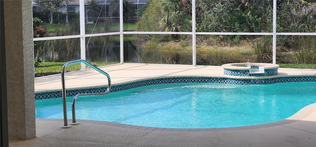 outdoor pool featuring a lanai, a patio area, and a jacuzzi