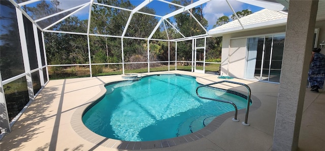 outdoor pool with a patio and glass enclosure