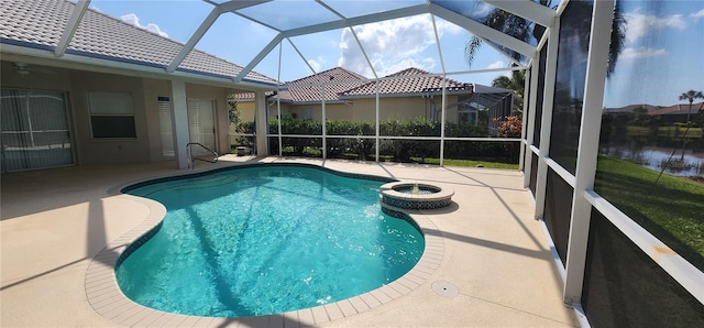 outdoor pool featuring a patio and glass enclosure