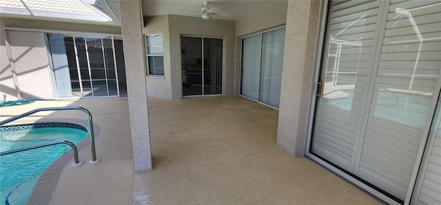 view of patio / terrace with a ceiling fan and an outdoor pool