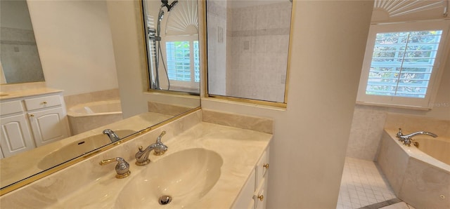 full bathroom with vanity and a bath