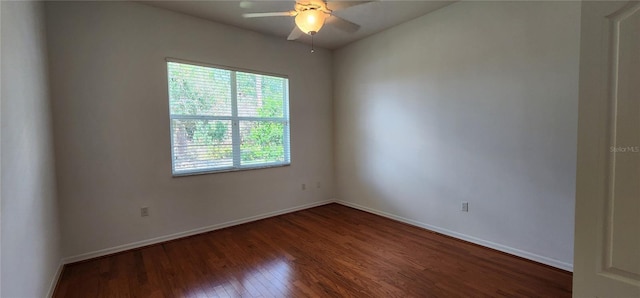 empty room with ceiling fan, wood finished floors, and baseboards