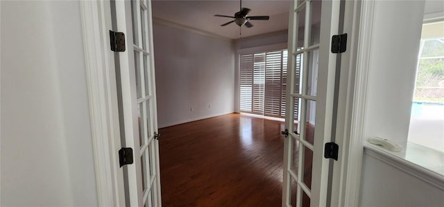 unfurnished room featuring baseboards, a ceiling fan, ornamental molding, wood finished floors, and french doors