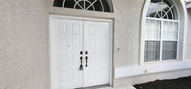 property entrance featuring stucco siding