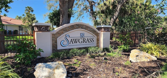 community sign featuring fence