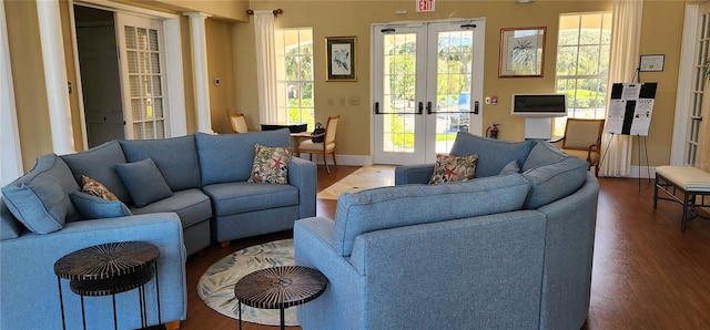 living room featuring plenty of natural light, baseboards, wood finished floors, and french doors