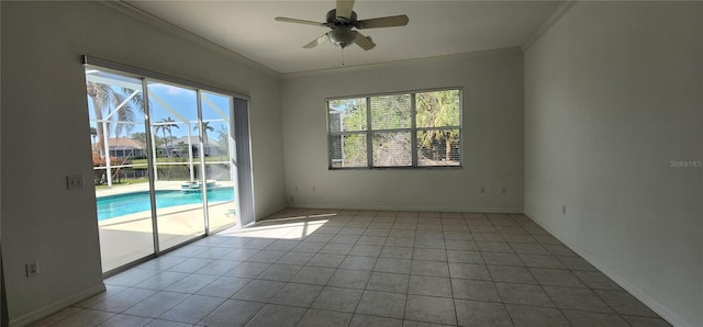 empty room with crown molding, tile patterned floors, a ceiling fan, and baseboards