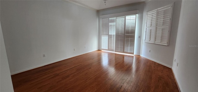 unfurnished room with hardwood / wood-style floors, baseboards, and ornamental molding