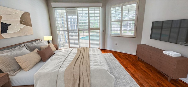 bedroom featuring baseboards and wood finished floors