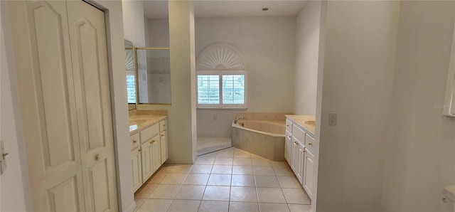 bathroom featuring tile patterned floors, a shower, vanity, and a garden tub