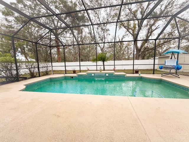 view of pool with a lanai, a fenced backyard, a fenced in pool, and a patio