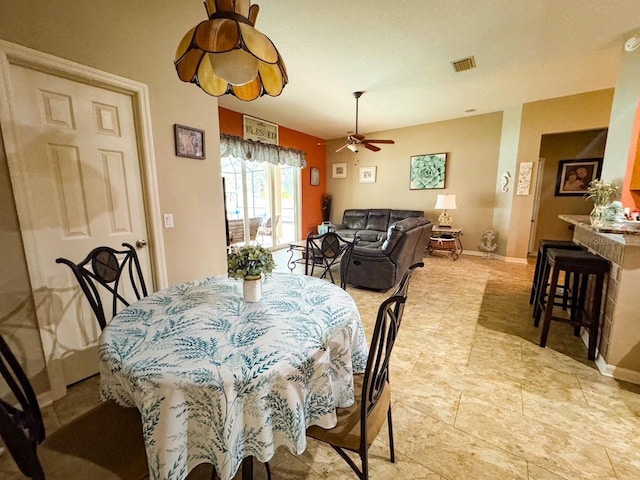 dining area with visible vents, baseboards, and a ceiling fan