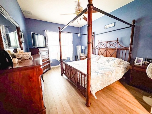 bedroom with light wood-type flooring, visible vents, and ceiling fan