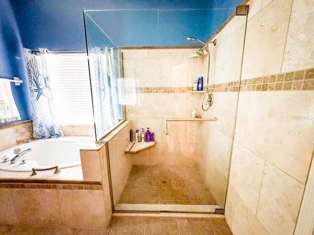 bathroom featuring a garden tub and tiled shower