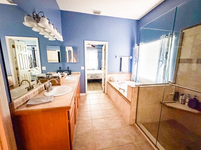 ensuite bathroom featuring a sink, a stall shower, tile patterned flooring, and connected bathroom